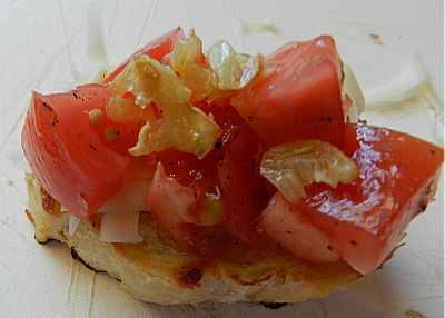 Toasted Baguette Topped With Tomatoes, Garlic, and Cheese