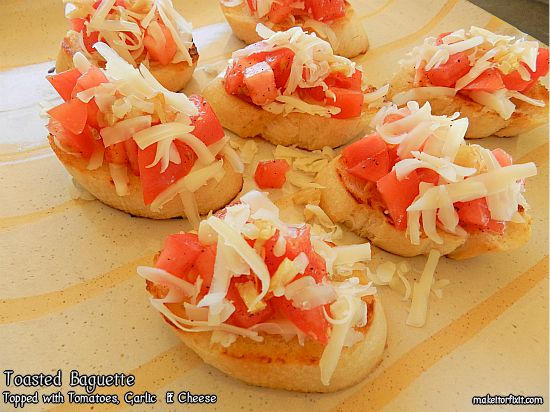 Toasted Baguette Topped With Tomatoes, Garlic and Cheese